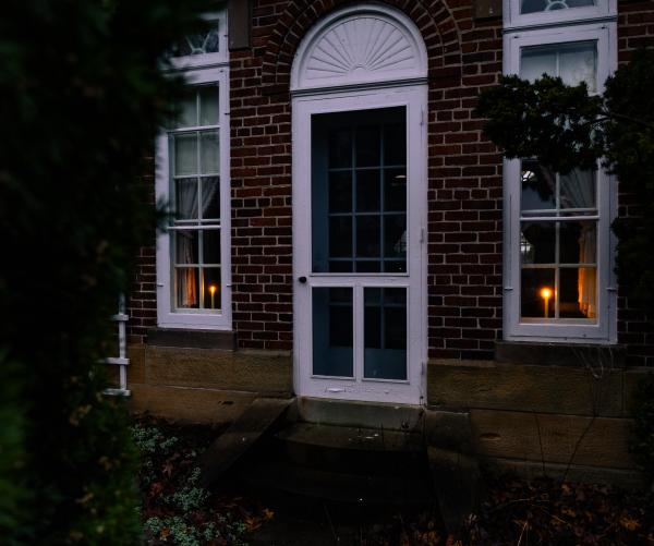 Two candlelights displayed in the windows of the Daweswood House Museum