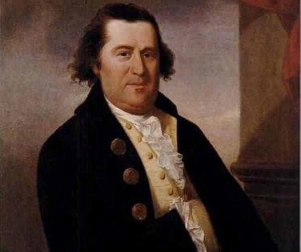 This photograph is of an oil painting of William Dawes. He is a caucasian man who is wearing a black coat with brass buttons and a white shirt. He has brown hair.
