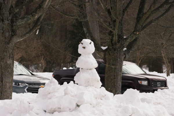 A snowman in a parking lot