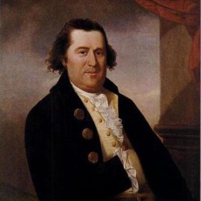 This photograph is of an oil painting of William Dawes. He is a caucasian man who is wearing a black coat with brass buttons and a white shirt. He has brown hair.